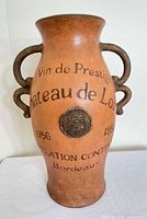 Front view showing full vase, graphics, handles