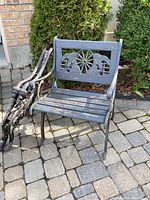Full view of bench and loose arms on stone patio