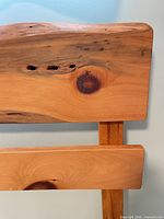 Close view of headboard showing live-edge pine, knots, finish