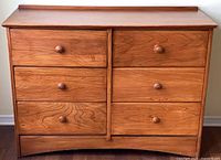 Front view of 6-drawer honey oak dresser showing overall design and drawer arrangement