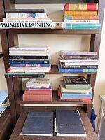Full bookshelf view showing all art books in lot