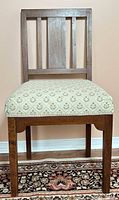 Front view of Mission style wood chair with beige patterned upholstered seat