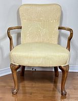 Front view of upholstered Queen Anne armchair