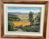 Framed oil landscape painting on wall