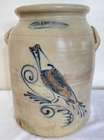 Full view of crock showing bird decoration and handles