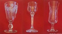 Three representative etched crystal glasses showing different shapes and patterns