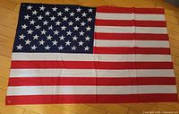 Full view of the flag laid flat showing stars and stripes