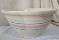 Side view of cream bowl with blue and pink bands