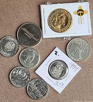 Group of eight coins spread out, showing obverse designs