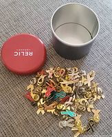 Pins spilled out beside Relic can