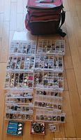 Overall lot showing tackle bag and array of plastic organizers filled with costume jewelry