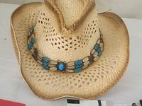 Front view of straw cowboy hat showing beaded band