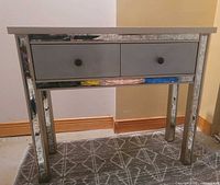 Front view of mirrored desk with drawers closed