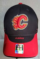 Front view of cap showing flaming C logo, FLAMES text, holographic sticker