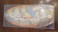 Front view of oval display card showing twelve quarters and Canada map graphic