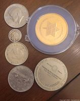 Group shot of all six coins laid out on tabletop