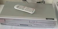 Front view of Sylvania combo deck with remote on top