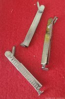 Three closed pipe tools on red surface