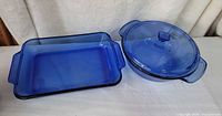 Both cobalt blue glass pieces with lid displayed