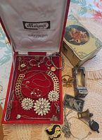 Open Makenji box and toffee tin showing assorted jewellery contents