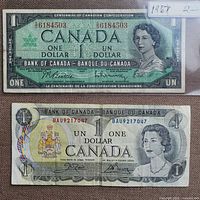 Fronts of both $1 notes showing serial numbers and designs
