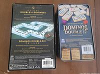 Backs of both domino sets showing contents lists and brand details