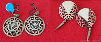 Both earring pairs side by side on red background