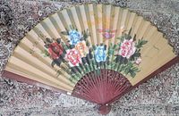 Full view of fan fully opened showing artwork and structure