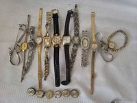 Full view of 12 wristwatches and 6 loose watch faces laid out