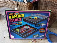 front of sealed retail box showing games, accessories list and graphics