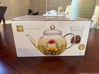 Front of sealed Teabloom Celebration Teapot box showing product image and details