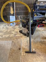 Vacuum with hose and wand in garage setting