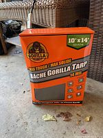 Front view of sealed box showing brand, size 10' x 14', thickness 14 mil