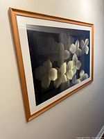 Angled view of entire framed print on wall showing image content and framing