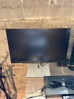 Front view of HP E23 G4 monitor on stand, cables visible