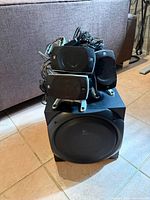 Full system stacked on subwoofer showing speakers, cabling, and control console