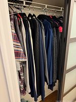 Side view of clothing hanging in closet