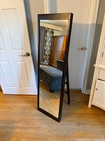 Front view of full-length mirror with wood frame and stand