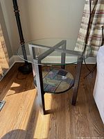 Full view of side table showing glass top, metal frame, slate shelf