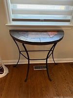 Front view of demilune console table under window
