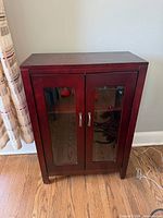 Front view of cabinet showing glass doors and handles