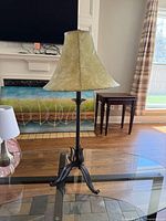 Full view of black metal table lamp with green shade