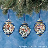Front view of the three ornaments hanging from tree branch