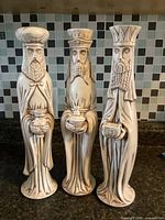 Front view of three ceramic wise men figurines
