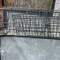 Wire grid pen panels leaning against wall