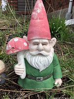 Gnome with red hat holding mushroom