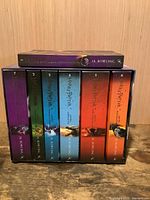 Front view of seven paperbacks inside slipcase plus Book 1 on top
