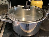 Overall view of stainless stock pot with glass lid