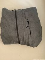 Hoodie folded showing zipper and chest pocket detailing