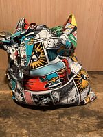 Carry bag full of Marvel print cornhole bags